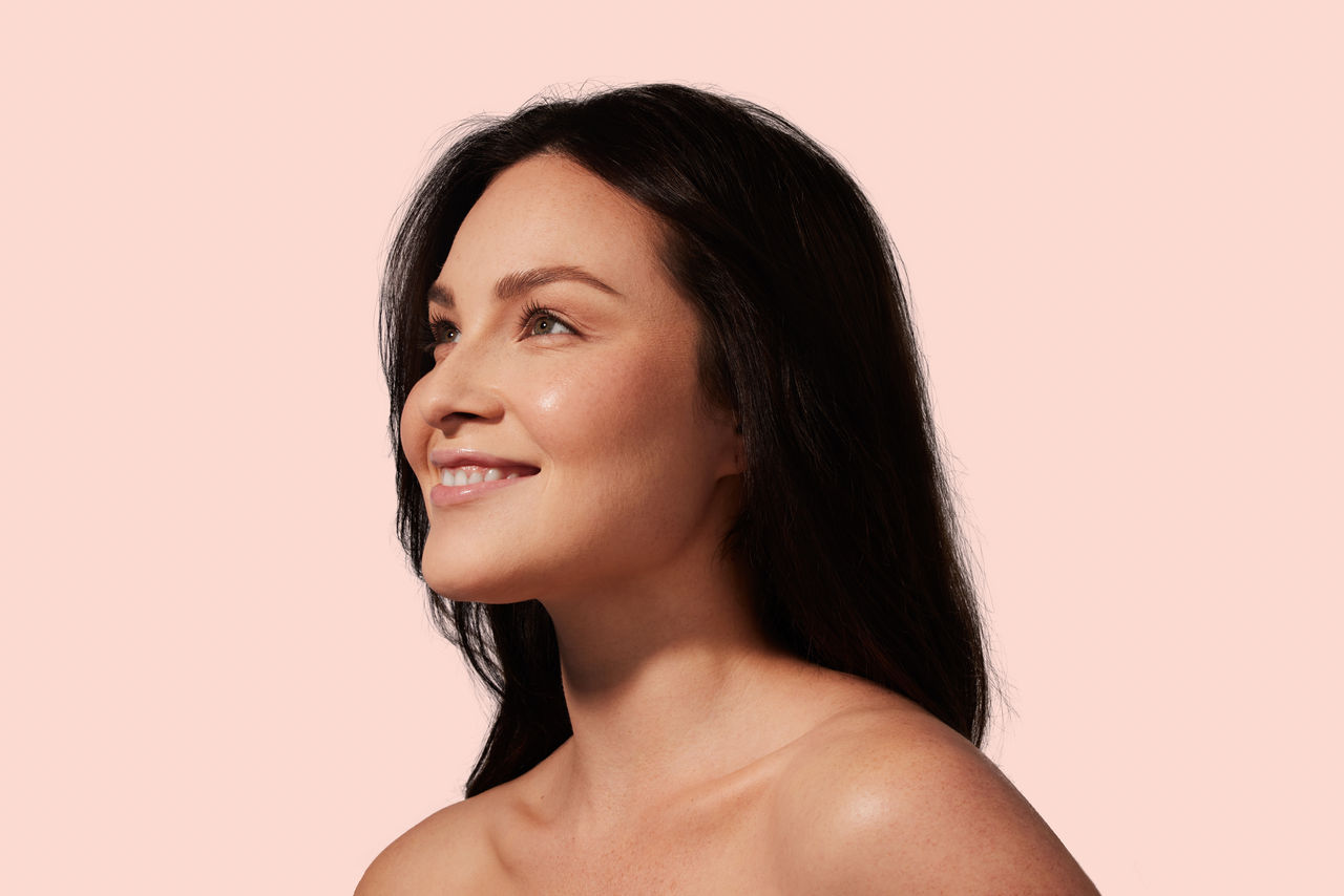 Woman smiling with her hands behind her head